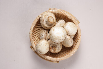 Fototapeta na wymiar White Champignon Mushroom in a Basket.
