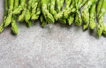 Fresh green asparagus on  concrete background.