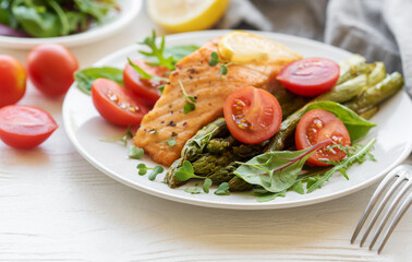 Baked Delicious salmon, green asparagus on  plate