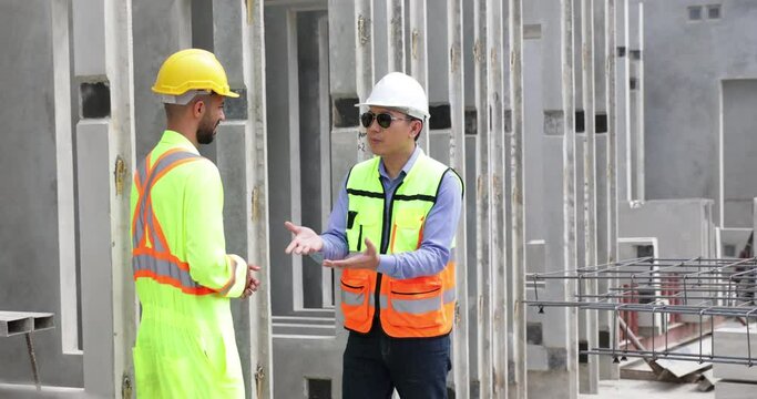 building and construction worker, Hiapanic latin and asian male in safety hard hat helmet working on steel wire mesh for concrete slab reinforcement at Prefabricated concrete walls Manufacturing