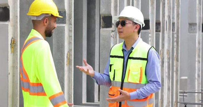 building and construction worker, Hiapanic latin and asian male in safety hard hat helmet working on steel wire mesh for concrete slab reinforcement at Prefabricated concrete walls Manufacturing