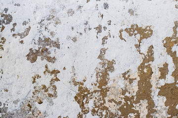 Texture of a whitewashed wall with traces of peeling paint