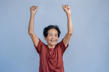 old woman raised her hand looking at the camera Show happiness and positive emotions. Happiness in daily life and life of the elderly.