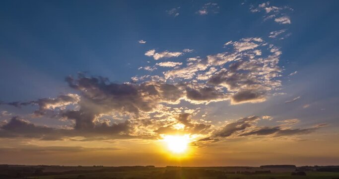 Time lapse clip of fluffy curly rolling storm clouds in windy weather in the evening