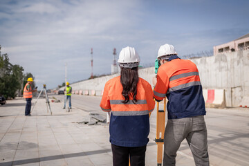 Portrait surveyors wearing uniform conversation notebook and blueprint check inspection by...