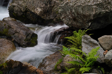 waterfall in the mountains with clear water low shutter