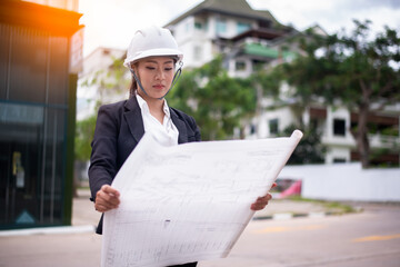 Portrait surveyors wearing uniform conversation notebook and blueprint check inspection by...