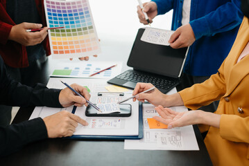  UX developer and ui designer brainstorming about mobile app interface wireframe design with...