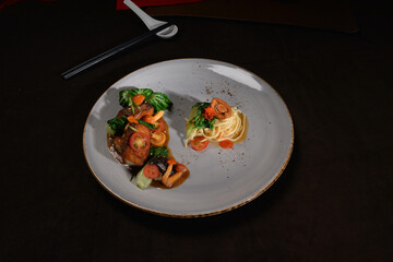 braised fried ee fu olive noodle pasta noodle mee with mini abalone and cod fish seafood vegetable main course fine dining cuisine halal food banquet restaurant menu on dark background