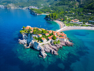 Island of Sveti Stefan near Budva in Montenegro. Beaches and coastline of the Adriatic Sea at summer time. Natural landscapes of Montenegro. Balkans. Europe. - obrazy, fototapety, plakaty