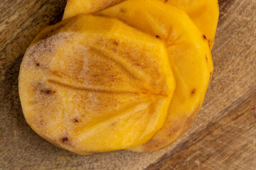 Half-ripe Orange persimmon, close up
