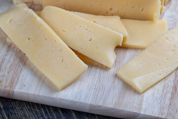 fresh cheese with holes cut into chunks