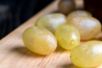 Homemade green unwashed grapes on a board