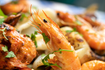 Shrimp; seafood; food; dish; macro photography; sea; restaurant; fried seafood; fish; octopus; appetizing; greens; parsley