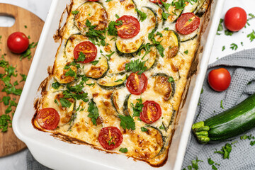Delicious freshly prepared and baked meal with zucchini and cheese dressing. Rustic home made food concept.