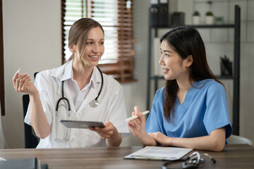 female doctor consulting with a female nurse at the clinic at the hospital