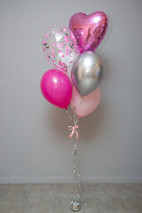 A set of pink and silver balloons for a boy's birthday