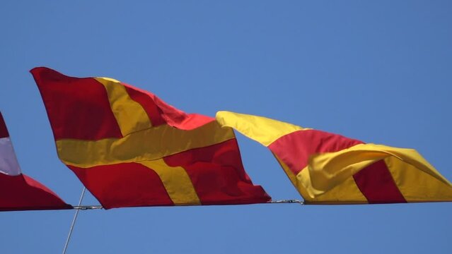Various nautical flags tied together with rope, Ship flags signals, morse code,