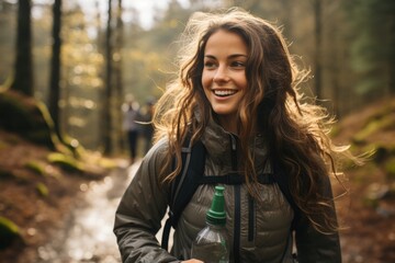 Woman hydrating with a water bottle during a hike - stock photography concepts