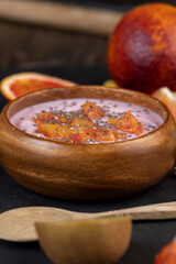 fresh yogurt with berries and fruits with red oranges