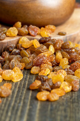 Dried yellow golden raisins on a board