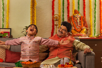 Grandfather and grandson enjoying a conversation during  Ganesh Chaturthi a festival celebrated in...