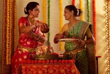 Nother and daughter  performing puja during Ganesh Chaturthi a festival celebrated in Maharashtra (...