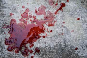 blood spills on the cement floor. concept photo illustration of murder and blood vomiting disease