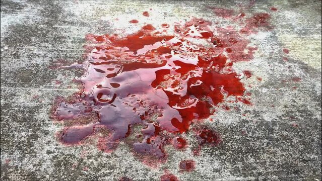 blood spills on the cement floor. concept photo illustration of murder and blood vomiting disease