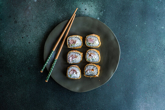 Overhead view of a plate of fried tuna maki rolls on a plate