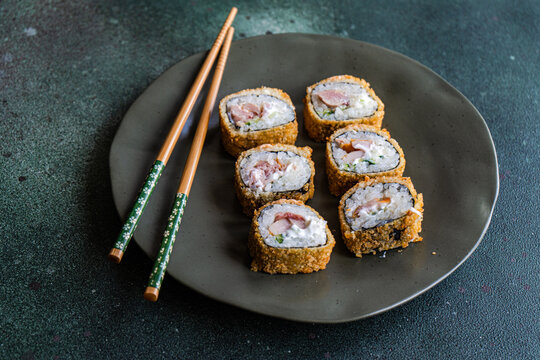 Close-up of a plate of fried tuna maki rolls on a plate