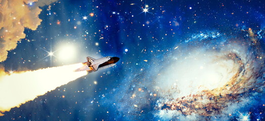 Shuttle launch in the clouds to outer space. Dark space with stars on background.Spaceship flight. Elements of this image furnished by NASA
