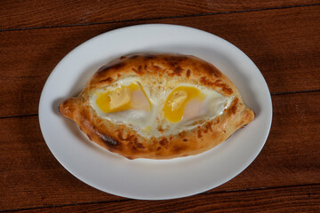 Khachapuri in Adjarian or Adjara khachapuri, boat, national Georgian cuisine, pastry with cheese and egg.Georgian cuisine.