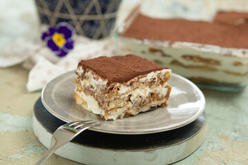 Piece of tiramisu cake, served on the table.
