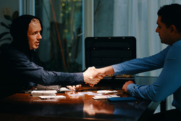 Cop who going undercover to catch drug dealers shaking hand of police officer