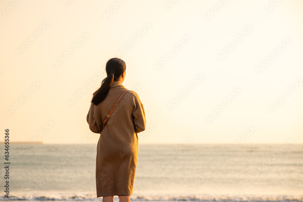 Canvas Prints woman look at the sea in the sunset time