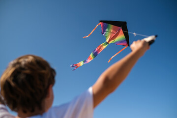 Child playing with rainbow kite