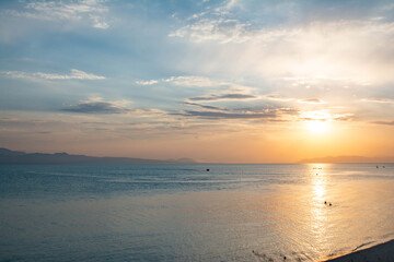 Sunset over the lake. Shining sun and lake