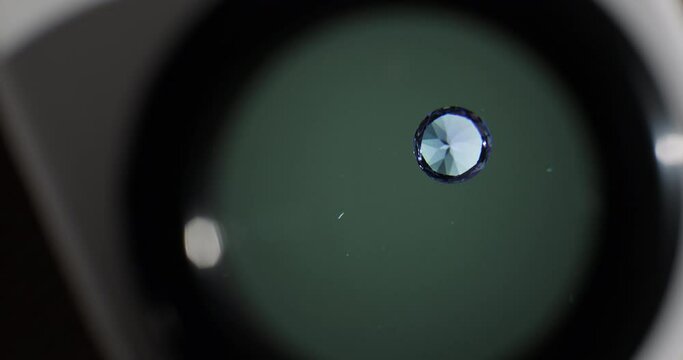 Close-up shot of sapphire gemstone under the microscope in the gemmological laboratory. Gem grading and valuation identification.