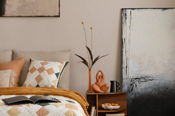 Stylish composition of orange bedroom interior with mock up poster frame, orange bedding, wooden...