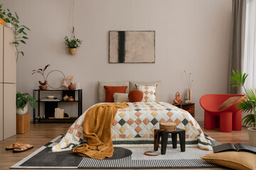 Warm and cozy bedroom interior with mock up poster frame, beige and orange bedding, patterned rug,...