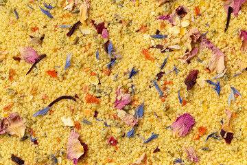 Couscous with dried flowers full frame close up as background
