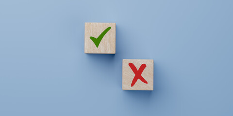 Analyze pros and cons. green tick and red cross in focus on wooden cube on blue background....