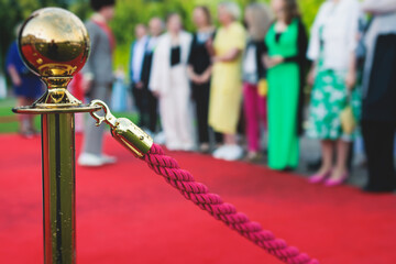 Red carpet with ropes and golden barriers on luxury party entrance, cinema premiere film festival...