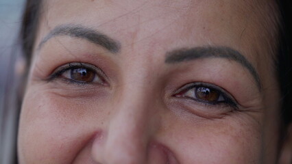 Fototapeta premium Happy woman macro eyes smiling at camera. A Middle-Aged person's gaze