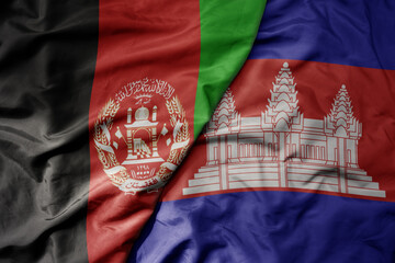 big waving realistic national colorful flag of afghanistan and national flag of cambodia .