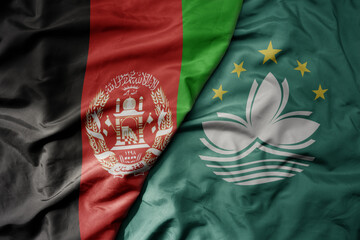 big waving realistic national colorful flag of afghanistan and national flag of Macau .