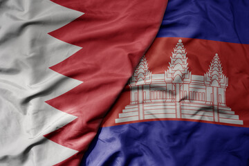 big waving realistic national colorful flag of bahrain and national flag of cambodia .