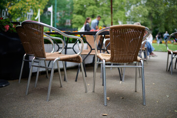 two chairs next to a table in outdoors cafe
