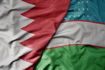 Obraz premium big waving realistic national colorful flag of bahrain and national flag of uzbekistan .